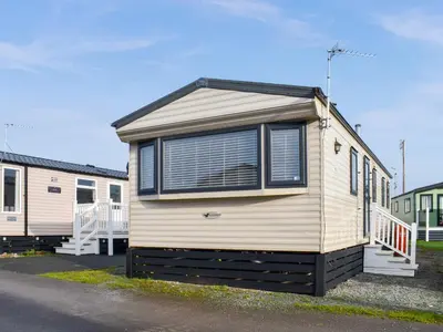 a small house with a window on the side of it at Stay And Sea in Heysham