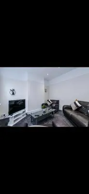 a living room with leather couches and a television at Cherry Loft in Liverpool