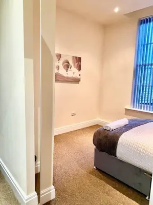 a bedroom with a bed and a window at City Centre 2 Bed 2 Bath Apartment in Preston