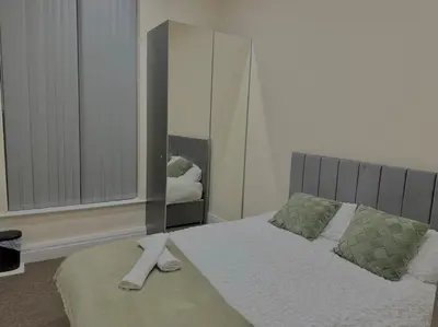 a bedroom with a bed and a large mirror at City Centre 2 Bed 2 Bath Apartment in Preston