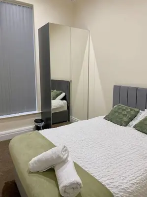 a bedroom with a bed with a towel on it at City Centre 2 Bed 2 Bath Apartment in Preston