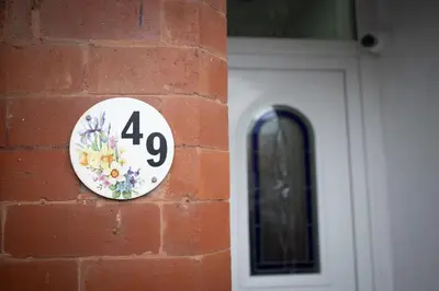 a plate on a brick wall next to a door at Lethbridge Villa 49 Apartment 3 Super Fibre WiFi, Free parking in Southport