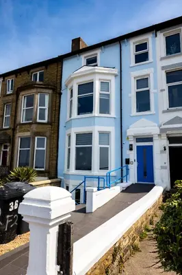 a blue and white house with a blue door at Sunbeam House 3 Morecambe in Morecambe