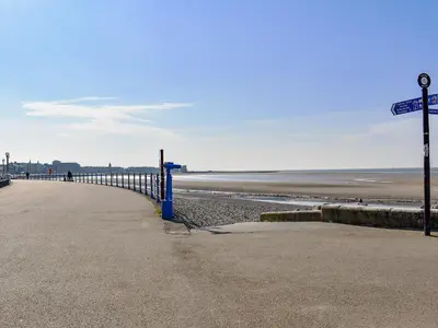a beach with a blue fence next to the ocean at Sand Dune - Uk48699 in Lancaster