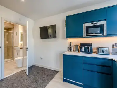 a kitchen with blue cabinets and a microwave at Sand Dune - Uk48699 in Lancaster