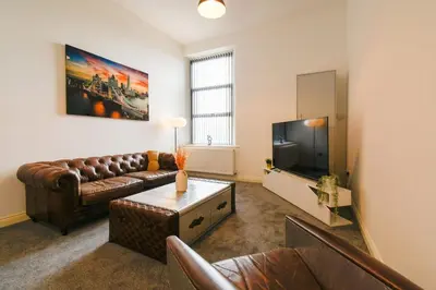 a living room with a couch and a tv at Suite in the center of Great Harwood in Great Harwood