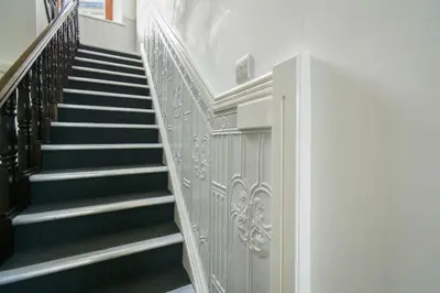 a staircase in a building with black and white at Suite in the center of Great Harwood in Great Harwood