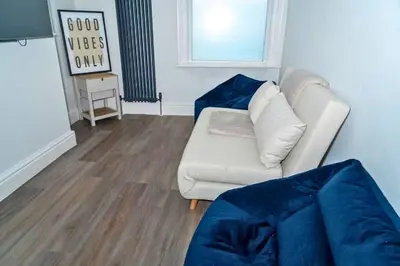 a living room with a white couch and a window at Sleek Apartment in Blackpool, Beach View, WiFi, Sleeps 6 in Blackpool