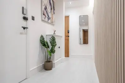a hallway with a potted plant and a mirror at Private Stay by Anfield Shared Kitchen Parking in Liverpool