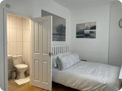 a bedroom with a bed and a toilet at Beautiful six bedroom townhouse citybreak close to city centre in Liverpool