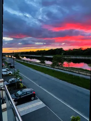 a car parked on the side of a road at sunset at Small Double Room in Lancaster Riverside - 15 Minutes Walk to City Centre in Torrisholme