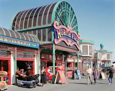 a street with people walking in front of a building at Willow Suite - 3br - Sleeps 8 - Central Blackpool in Blackpool