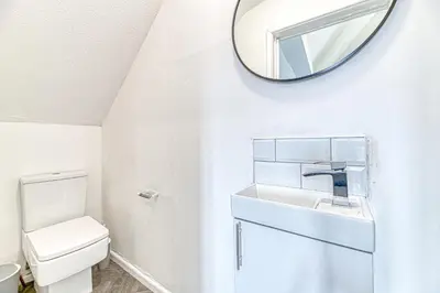 a white bathroom with a sink and a mirror at Fairhaven View Apartments - Lytham St Annes in Lytham St Annes