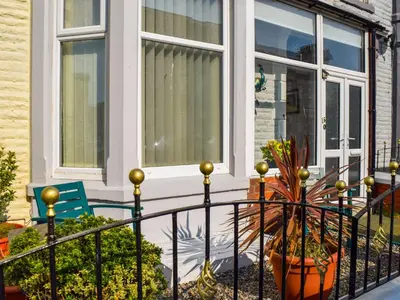 a house with a balcony with a potted plant at The Sandcastle in Blackpool