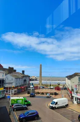 a street with cars parked in a parking lot near the ocean at North View in Blackpool