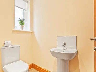 a bathroom with a toilet and a sink at Tower Cottage in Arnside