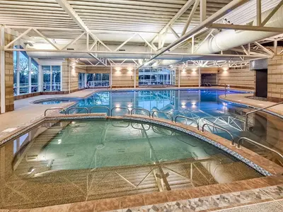 a large indoor swimming pool in a building at Hollins Cottage in Silverdale