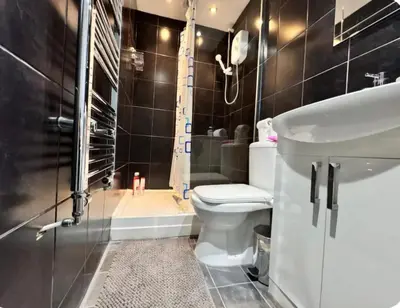 a bathroom with a toilet and a shower and a sink at Room 5 Shared House in L6 in Liverpool