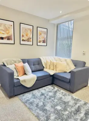 a blue couch sitting in a living room at Room 6 Shared House in L6 in Liverpool