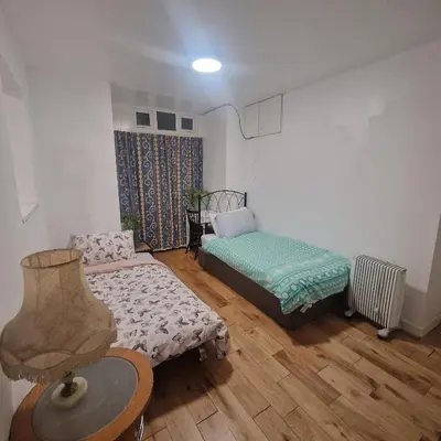 a room with a bed and a couch and a table at Ground Floor Holiday flat in Blackpool