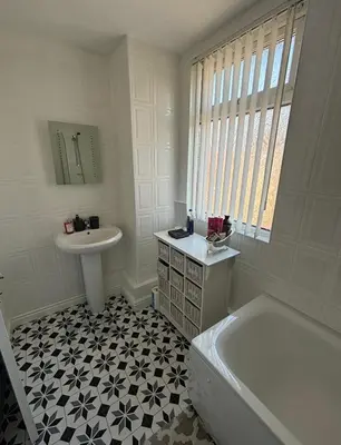 a white bathroom with a sink and a tub and a sink at Cozy Double Room with 5 Minute Walk to Anfield Stadium ideal for Matchdays in Liverpool