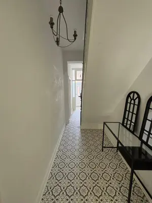a hallway with a glass table and a chandelier at Cozy Double Room with 5 Minute Walk to Anfield Stadium ideal for Matchdays in Liverpool