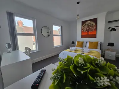 a bedroom with a bed and a desk with a computer at Room 3 Shared house in Kensington in Liverpool