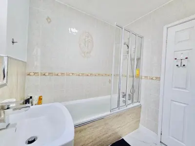 a bathroom with a tub and a sink and a shower at Room 2 Shared House in Bootle in Litherland