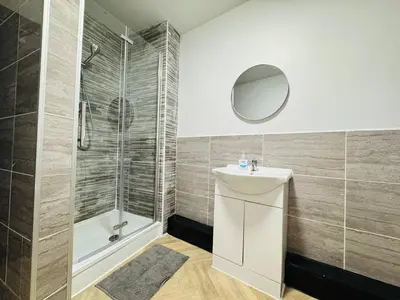 a bathroom with a sink and a shower at Pembroke Place Private room 5 in Liverpool