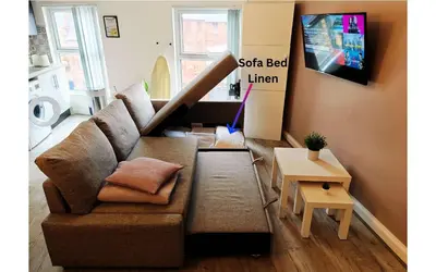 a living room with a couch and a tv at Lodginet Stays - County Luxe - 2BR Flat 1 in Liverpool