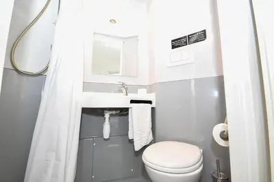 a small bathroom with a toilet and a sink at Spacious 6 Bedroom Apartment in Liverpool in Liverpool