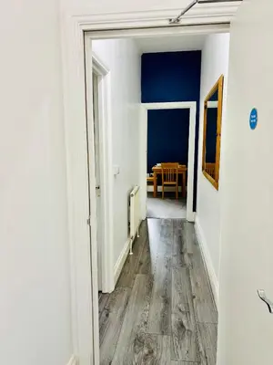 an empty hallway with a table in a dining room at Garrick's Suite-Home away from Home- suitable for couples retreat, Contractors and NHS- free parking in Southport
