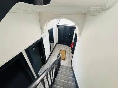 a view of a stairway with black doors and a stair case at Pembroke Place Private Room 4 in Liverpool