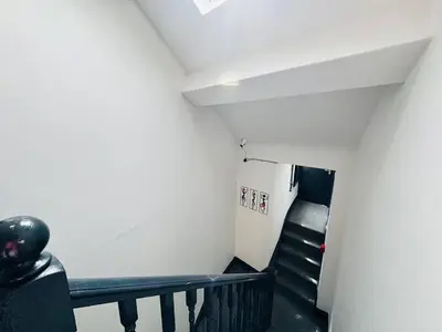 a staircase in a room with white walls and black stairs at Pembroke Place Private Room 7 in Liverpool