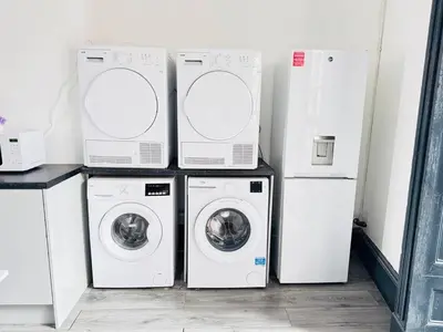 four washers and dryers in a laundry room at Pembroke Place Private Room 11 in Liverpool