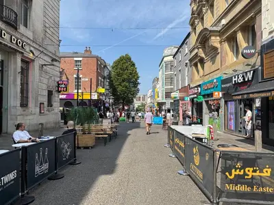 a city street with tables and people walking down the street at Bold Street Studio IV in Liverpool