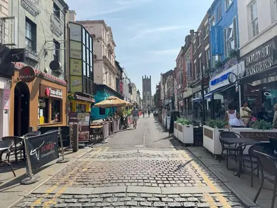 an empty city street with tables and chairs and buildings at Bold Street Studio VIII in Liverpool