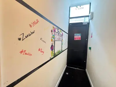 a hallway with a door with graffiti on the wall at Bold Street Studio VI in Liverpool