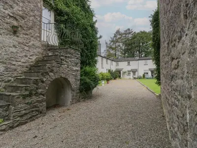 an alley in front of a stone building at Huntsman's Cottage in Grange Over Sands