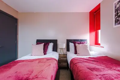 two beds sitting next to each other in a room at Modern 2BR near Wigan Town Centre in Wigan