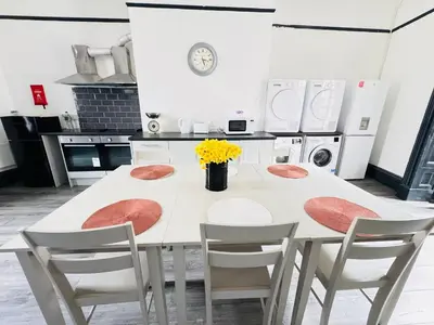 a kitchen with a white table and chairs at Pembroke Place Private Room 5B in Liverpool