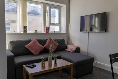 a living room with a couch and a table at One Bedroom Flat by Brookland Stays Serviced Accommodation Short Lets Blackpool with Free WiFi in Blackpool