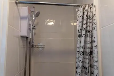 a bathroom with a shower with a shower curtain at One Bedroom Flat by Brookland Stays Serviced Accommodation Short Lets Blackpool with Free WiFi in Blackpool