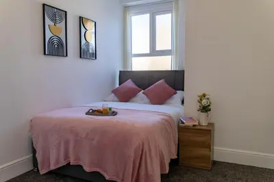 a bedroom with a bed with a tray of fruit on it at Brookland Stays Blackpool 1BR Apartment Sleeps 4 WiFi in Blackpool