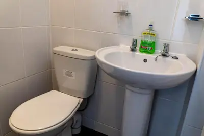 a bathroom with a toilet and a sink at Brookland Stays Blackpool 1BR Apartment Sleeps 4 WiFi in Blackpool