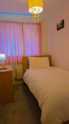 a bedroom with a white bed and a window at Modern luxury 3-bedroom guesthouse in Wigan in Wigan