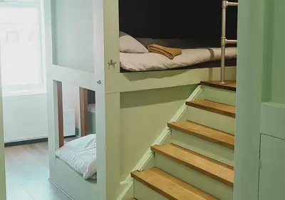 a room with stairs leading to a bunk bed at Pitchside Place Walk to Anfield sleeps 19 in Liverpool
