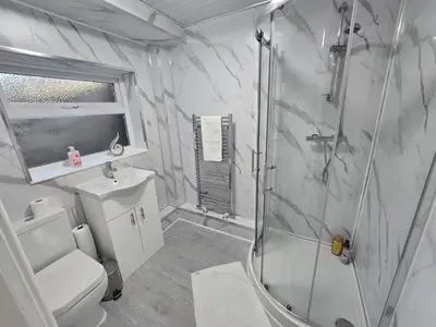 a bathroom with a shower and a toilet and a sink at House 5 Minutes from Sefton Park in Liverpool
