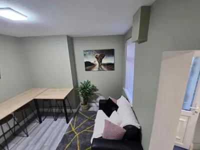 a living room with a couch and a table at Room 1 Shared house 5 min from Sefton Park in Liverpool