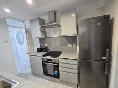 a kitchen with a stainless steel refrigerator and a sink at Room 2 Shared house 5 min from Sefton Park in Liverpool